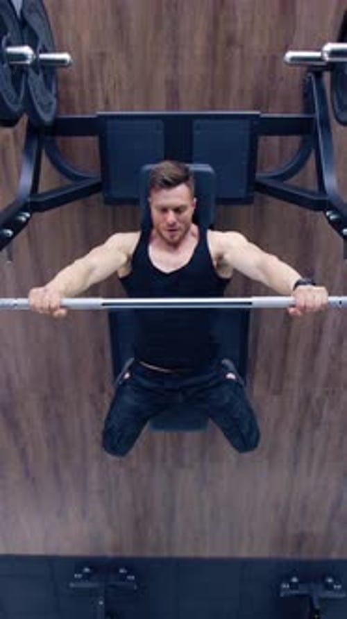 Bodybuilder athlétique faisant des exercices avec haltères.