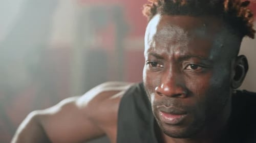 Closeup Portrait of African Sportsman Training in Gym Young Black Guy is Doing Exercises in Fitness