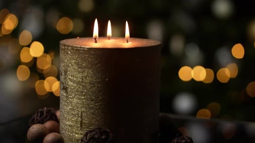 Close Up of Golden Christmas Candle Burning
