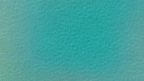 Aerial Topdown View of Serene Sea Gradient and Beach