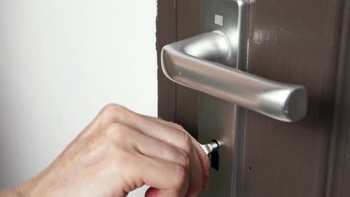 Hand Locking Up The Door With Key