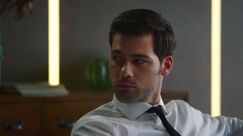 Closeup Confident Businessman Thinking in Modern Interior. Portrait of Serious Entrepreneur Looking