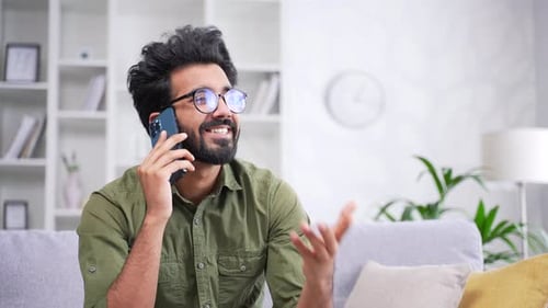 Smiling Young Adult Talking on Mobile Phone