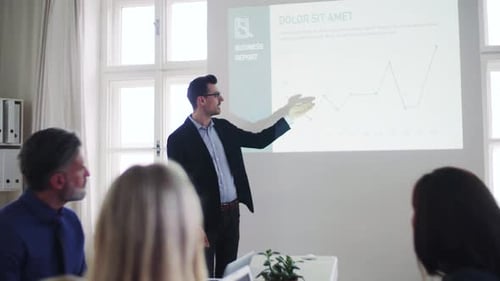Businessman giving a presentation to colleagues in a modern office space