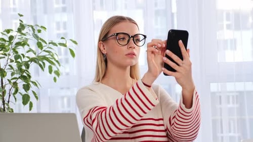 Young Woman Talking to Smart Phone Video Call