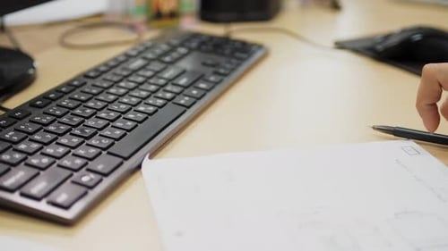 Woman Works with Computer and Detail Drawing at Wooden Table