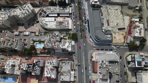 Top view cars drive down the street of a busy city