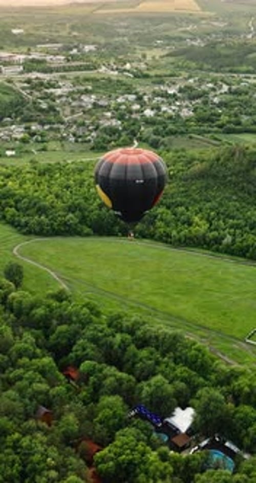 Aerial drone view of a hot air balloon flying above Chisinau, Moldova. Vertical