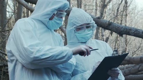 Forensic Specialist Working in the Forest Police Criminalists Collecting Evidence and Making
