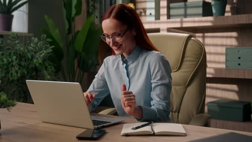 Happy Woman Working on Laptop and Stretching at Desk