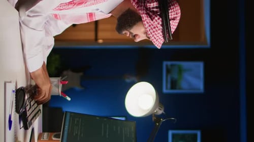 Man Working at Desk Late at Night