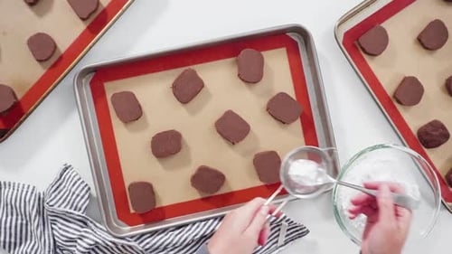 Step By Step Flat Lay Unbaked Chocolate Cookies on a Baking Sheet Lined Up with Silicone Liner