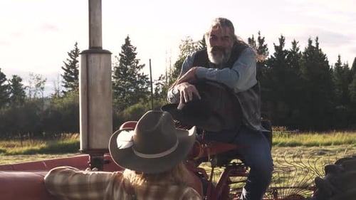 Happy Farmers Talking at Tractor in Sunny Rural Farm Field Adult