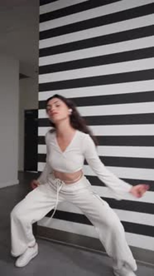 Strong athletic woman performs acrobatic dance with a handstand trick