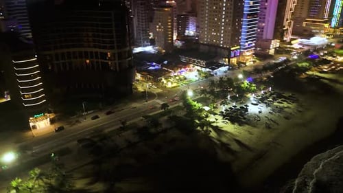 Glowing City Lights Revealing Vibrant Nighttime Shoreline Capturing Metropolitan Energy with
