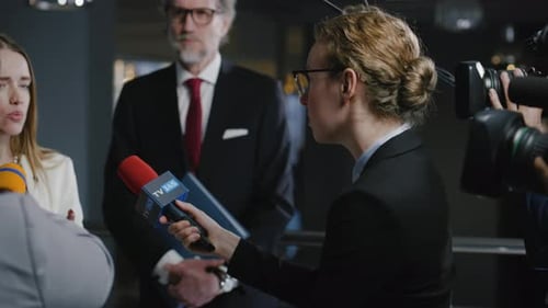 Panel Giving Press Conference with Microphones
