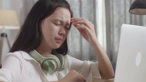 Stressed Asian Teenager Suffer From Headache Bad Vision Sight Problem While Use Laptop At Home Table