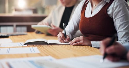 Business Professionals Take Notes in a Corporate Office