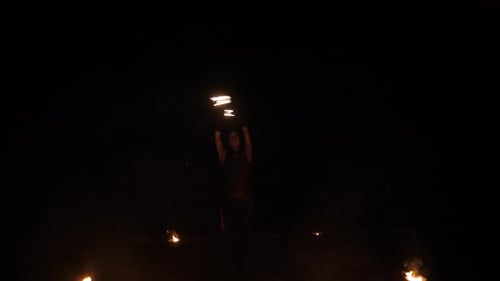 Woman Performs Fire Dance at Night