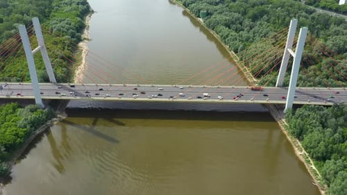Car traffic on hanging sea bridge over bay in city view from above. Aerial View