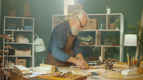 Woodworker Shaping Wood in Workshop