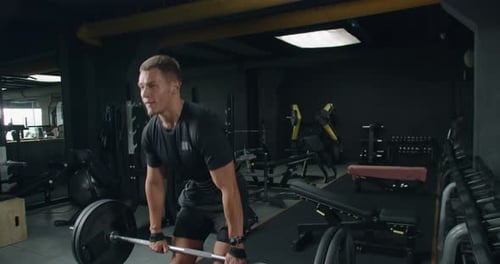 Determined Man Lifting Weights at Gym Focused Fitness Session