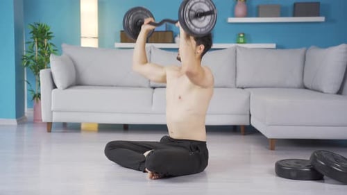 Young Adult Working Out with Barbell at Home