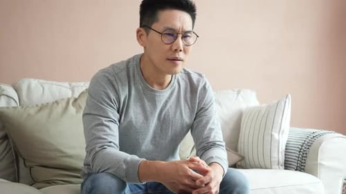 Adult Male Speaking on a Couch Indoors