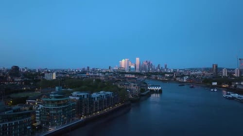 Aerial View Over A Calm River Flowing Through A City Centre