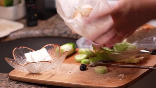Woman Prepares a Sandwich with Cheese and Vegetables