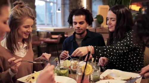 Friends enjoying meal together in restaurant setting