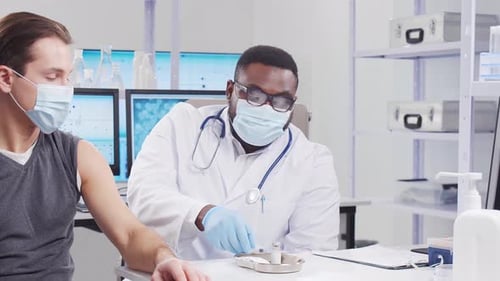 Doctor Giving Vaccine to Patient in Clinic