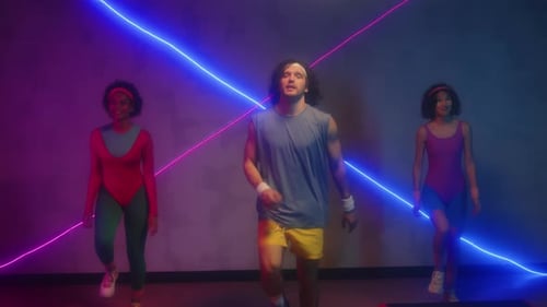 Instructor and Two Women Practicing Aerobics in Retro Studio