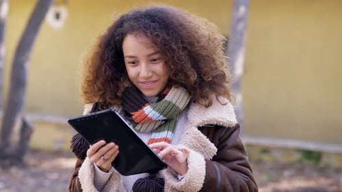 aplicativo, dispositivo - atraente jovem hispânica sorrindo usando tablet digital