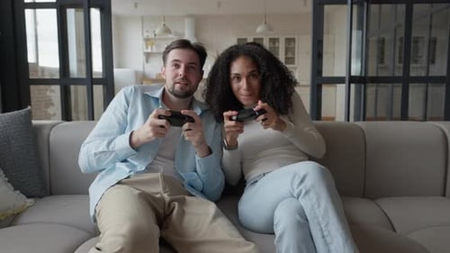 Couple Plays Video Games Together at Home