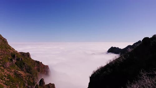 Aerial drone view of a cloud covered valley, in middle of mountains, in Madeira