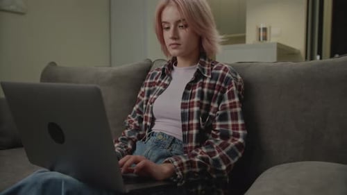 Young Woman Working on Laptop at Home