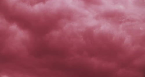 Dreamy Pink Sky with Drifting White Clouds