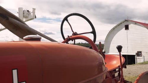 Red Tractor Parked on Sunny Rural Farm Absence