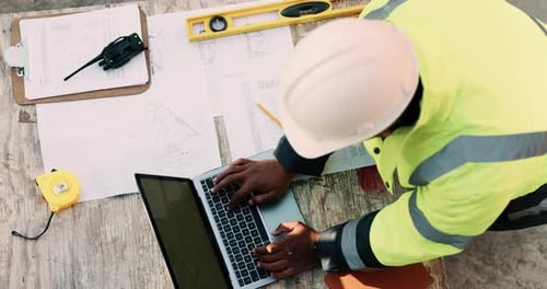 Construction, laptop and above of man for planning, building design and report for renovation