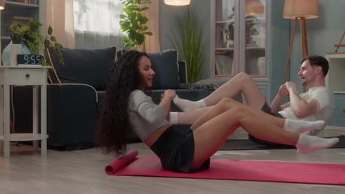 Couple Doing Core Workouts Together in Living Room