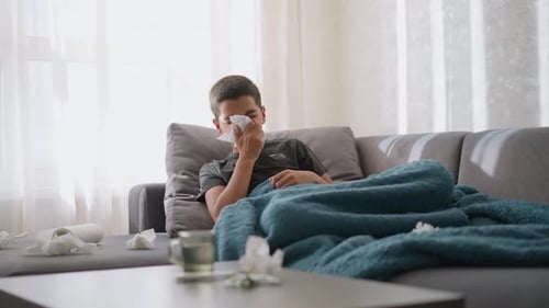 Sick Young Adult Resting at Home with Cold