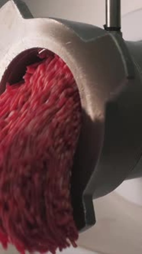 Close Up of Meat Grinder Mincing Red Meat