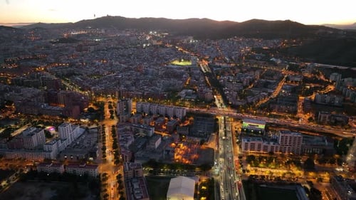 Barcelona at night, aerial view. Streets with busy car traffic and city lights. Catalonia, Spain