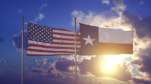 Waving Flags of United States and Texas Against Sunset Sky
