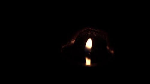 Single Candlelight Flickering Peacefully in the Dark