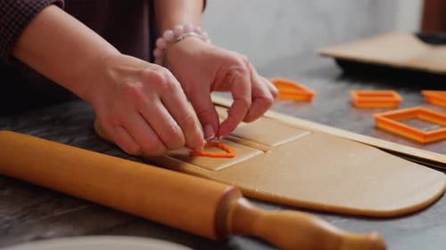 Woman Cuts Cookie Shapes From Dough