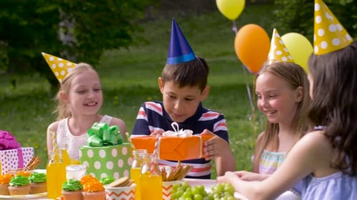 Kids opening gifts at a birthday party