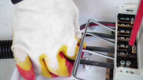 Close Up Hand Tightening Electrical Wires