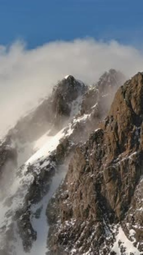 Snowy Mountain Peaks With Rolling Clouds. British Columbia, Canada.
